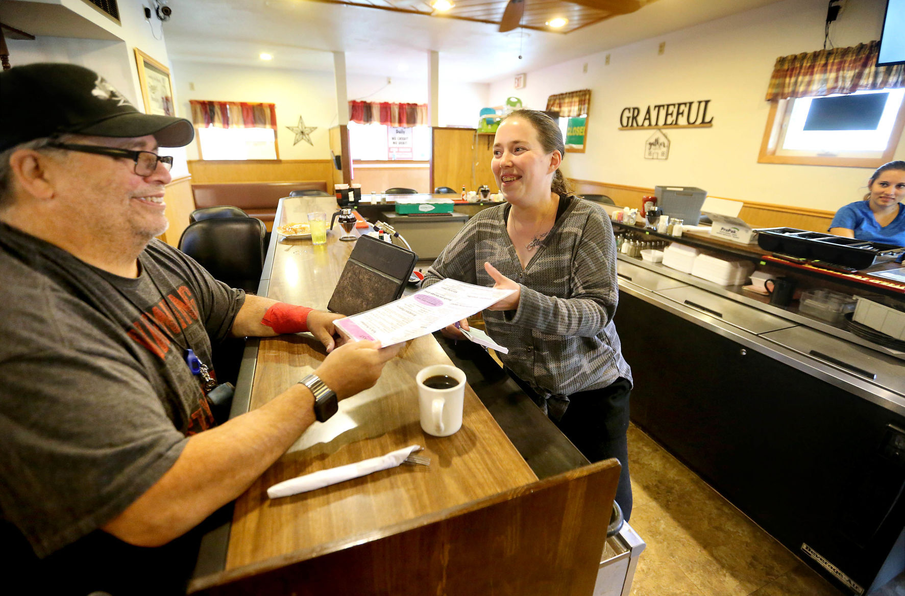 Edward Mumby, of Platteville, Wis., places an order with co-owner Jessica Fields at Katina’s Kitchen in Dickeyville, Wis., Saturday,    PHOTO CREDIT: JESSICA REILLY