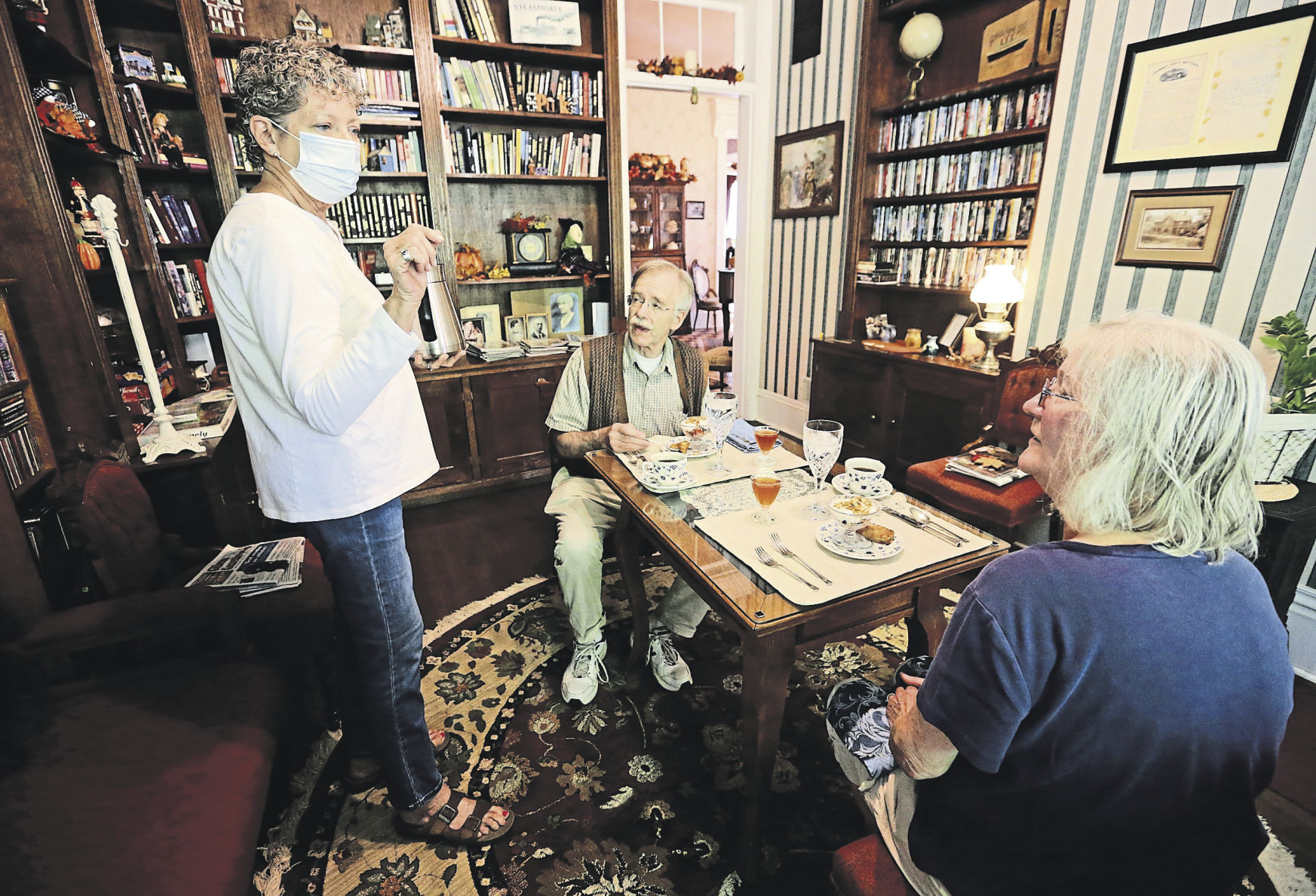 Owner Carol Gebelt (left) talks with Mark Kraemer and his wife, Christine, of Wilmette, Ill., during breakfast at The Steamboat House Bed & Breakfast in Galena, Ill. Besides taking care of their guests, owners of bed-and-breakfasts spend their days jumping from task to task.    PHOTO CREDIT: JESSICA REILLY