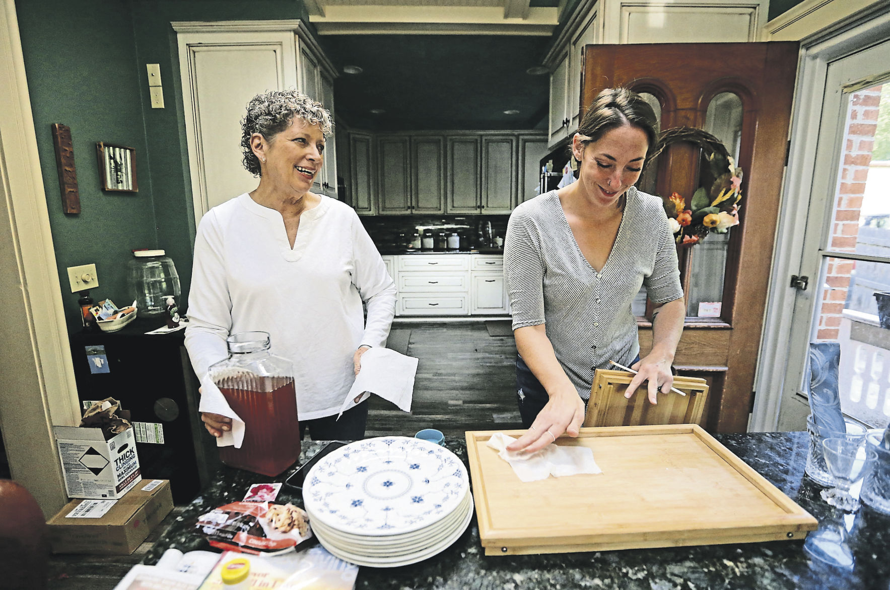 Owner Carol Gebelt (left) talks with her daughter Katie Burcham while preparing breakfast for guests at The Steamboat House Bed and Breakfast in Galena, Ill.    PHOTO CREDIT: JESSICA REILLY