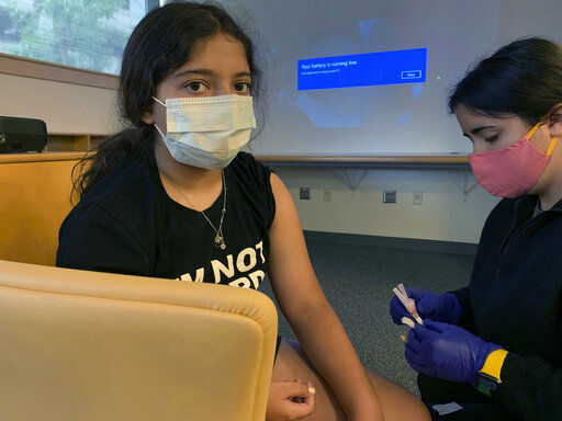 This photo provided by Nisha Gandhi shows Maya Huber taking part in Pfizer COVID-19 vaccine study at Rutgers University on June 14 2021 in New Brunswick, N.J. Maya does not know if she is receiving the vaccine or the placebo. Pfizer says its COVID-19 vaccine works for children ages 5 to 11. The vaccine maker said Monday, Sept. 20, it plans to seek authorization for this age group soon in the U.S., Britain and Europe. The vaccine made by Pfizer and its German partner BioNTech already is available for anyone 12 and older. (Nisha Gandhi via AP)    PHOTO CREDIT: HONS