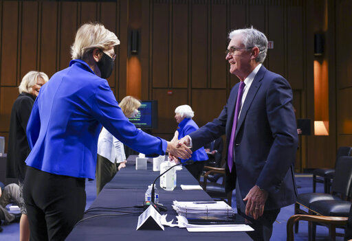 Sen. Elizabeth Warren, D-Mass., greets Federal Reserve Chairman Jerome Powell before a Senate Banking, Housing and Urban Affairs Committee hearing on the CARES Act on Capitol Hill, Tuesday, Sept. 28, 2021 in Washington. (Kevin Dietsch/Pool via AP)    PHOTO CREDIT: Kevin Dietsch
