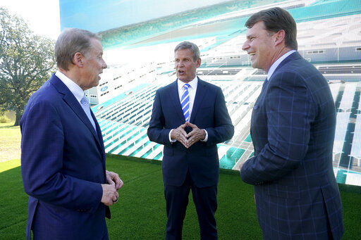 Ford Executive Chairman Bill Ford, left, and Jim Farley, Ford president and CEO, right, talk with Tennessee Gov. Bill Lee, center, after a presentation on the planned factory to build electric F-Series trucks and the batteries to power future electric Ford and Lincoln vehicles Tuesday, Sept. 28, 2021, in Memphis, Tenn. The plant in Tennessee is to be built near Stanton, Tenn. (AP Photo/Mark Humphrey)    PHOTO CREDIT: Mark Humphrey