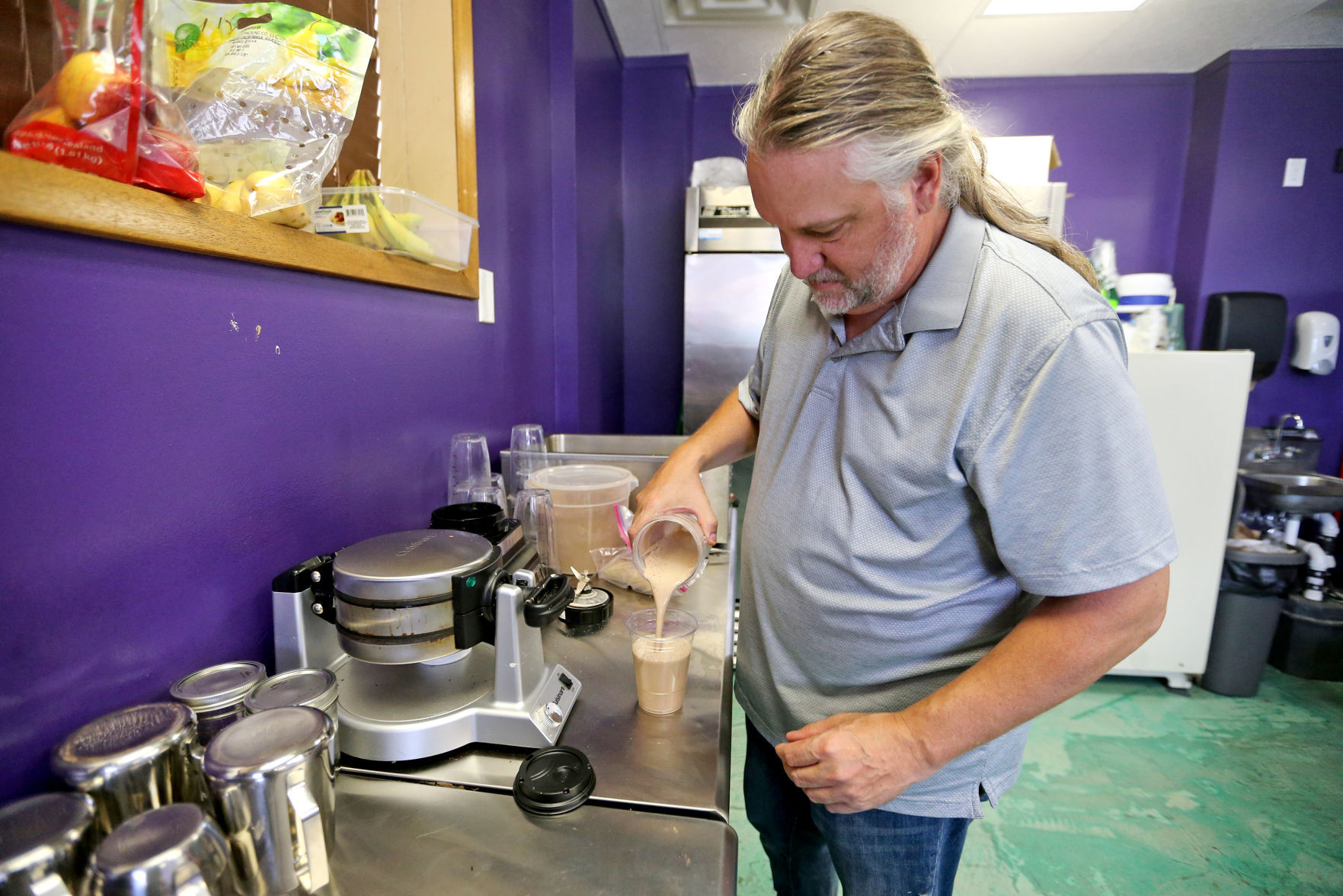 Owner Steve Thompson makes a cacao milk at Kakow Kanteen, at First and Locust streets in Dubuque, on Monday.    PHOTO CREDIT: JESSICA REILLY