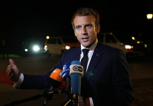 French President Emmanuel Macron speaks with the media as he arrives for a dinner, prior to an EU summit, at the Brdo Castle in Kranj, Slovenia, Tuesday, Oct. 5, 2021. EU leaders are meeting Tuesday evening to discuss increasingly tense relations with China and the security implications of the chaotic U.S.-led exit from Afghanistan, before taking part in a summit with Balkans leaders on Wednesday. (AP Photo/Darko Bandic)    PHOTO CREDIT: Darko Bandic