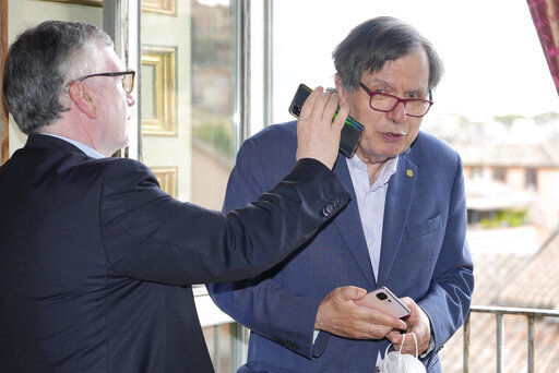 Italian theoretical physicist Giorgio Parisi, right, is passed phone calls by colleague Massimo Inguscio, president of the Italian National Research Council, as he arrives at the Accademia dei Lincei, Tuesday, Oct. 5, 2021, in Rome, after being awarded the 2021 Nobel Prize for Physics, together with Syukuro Manabe and Klaus Hasselmann, by The Royal Swedish Academy of Sciences in Stockholm. (AP Photo/Domenico Stinellis)    PHOTO CREDIT: Domenico Stinellis