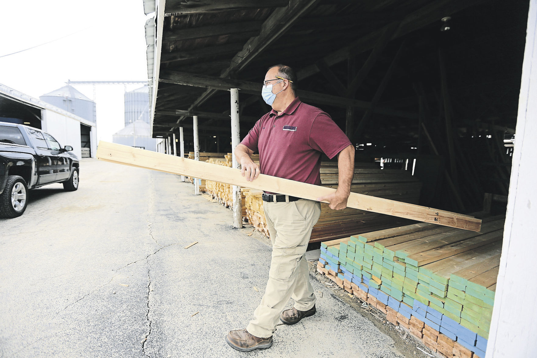 Pete Korth, a salesman with Hoskins Building Center, helps load some lumber. The longtime Elizabeth, Ill., business, began 167 years ago. Williams Hoskins opened it after finding success in the Gold Rush.    PHOTO CREDIT: Dave Kettering