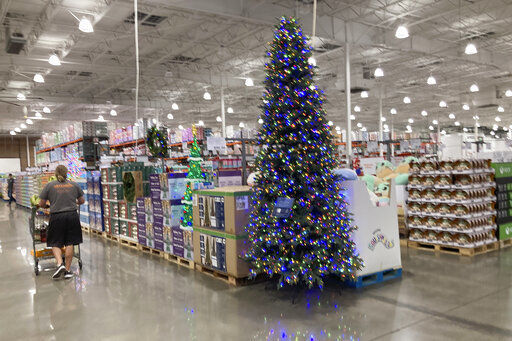 A lone shopper pushes a cart past a display for Christmas sales in a Costco warehouse late Thursday, Sept. 23, 2021, in Lone Tree, Colo. Companies that typically hire thousands of seasonal workers are heading into the holidays during one of the tightest job markets in decades, making it unlikely they’ll find all the workers they need. For shoppers, it might mean a less than jolly holiday shopping experience, with bare store shelves and online orders that take longer than usual to fill. (AP Photo/David Zalubowski)    PHOTO CREDIT: David Zalubowski