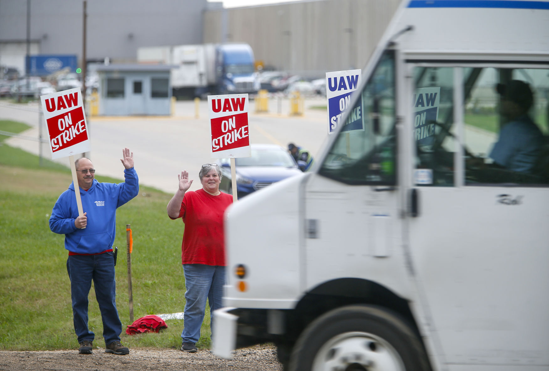 John Deere Dubuque Works union employees (from left) Rick Heid and Sheila Stirm picket outside the south entrance to the plant on Thursday, Oct. 14, 2021.    PHOTO CREDIT: Dave Kettering