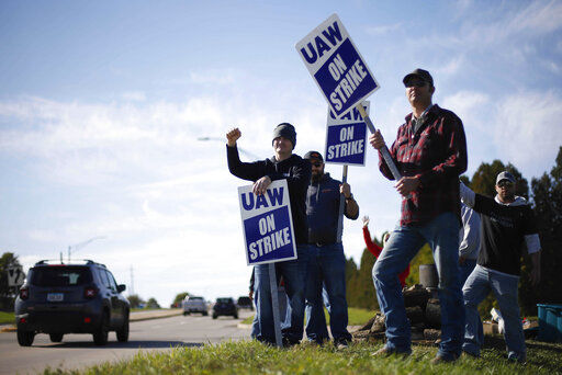 Members of the United Auto Workers strike outside of the John Deere Engine Works plant on Ridgeway Avenue in Waterloo, Iowa. Contract talks between Deere & Co. and its 10,000 striking workers have resumed, but it wasn