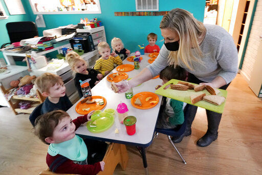 Amy McCoy serves lunch to preschoolers at her Forever Young Daycare facility in Mountlake Terrace, Wash. Child care centers once operated under the promise that it would always be there when parents have to work. Now, each teacher resignation, coronavirus exposure, and day care center closure reveals an industry on the brink, with wide-reaching implications for an entire economy