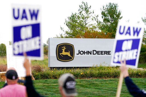 Members of the United Auto Workers strike outside of the John Deere plant in Ankeny, Iowa. More than 10,000 striking Deere & Co. workers were voting today on a new contract offer from the tractor maker, but this third deal is strikingly similar to a contract that 55% of workers rejected two weeks ago.    PHOTO CREDIT: Charlie Neibergall