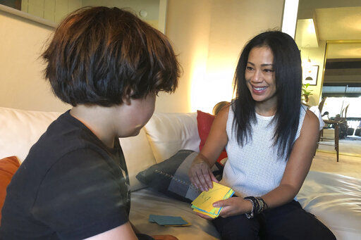 Keryn Francisco interacts doing math flash cards with her 10-year-old son Reve Francisco in Alameda, Calif. Francisco