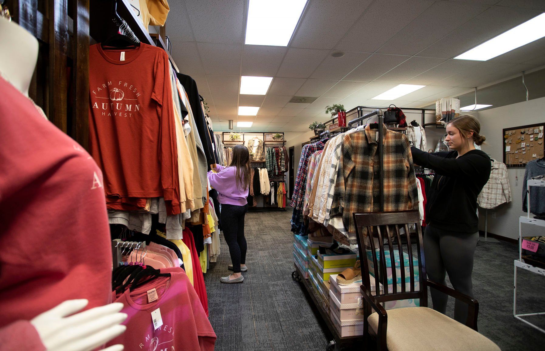 Kaeli Vorwald (left) and Morgan Mescher browse through clothes at Just For You Boutique.    PHOTO CREDIT: Stephen Gassman