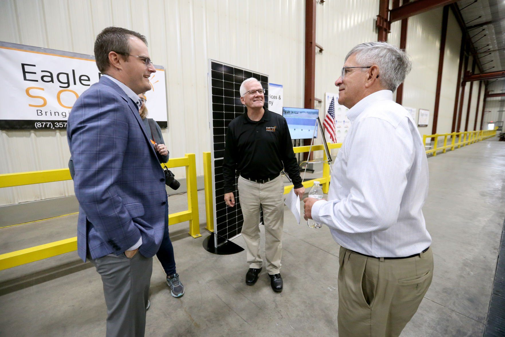 Iowa Lt. Gov. Adam Gregg (from left); Larry Steffen, executive vice president of sales and marketing at Eagle Point Solar; and Dave Buchheit, vice president of operations at FarmTek, talk during an event at FarmTek in Dyersville, Iowa, on Wednesday, Nov. 10, 2021.    PHOTO CREDIT: JESSICA REILLY