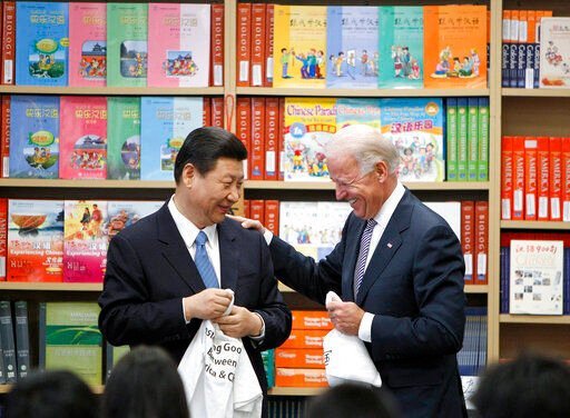 FILE - Chinese Vice President Xi Jinping and Vice President Joe Biden hold T-shirts students gave them at the International Studies Learning Center in South Gate, Calif., Feb. 17, 2012. As President Joe Biden and Xi Jinping prepare to hold their first summit on Monday, Nov. 15, the increasingly fractured U.S.-China relationship has demonstrated that the ability to connect on a personal level has its limits. Biden nonetheless believes there is value in a face-to-face meeting, even a virtual one like the two leaders will hold Monday evening. (AP Photo/Damian Dovarganes, File)    PHOTO CREDIT: Damian Dovarganes