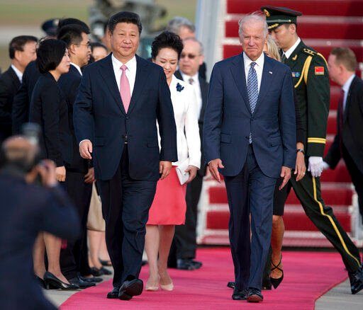 FILE - Chinese President Xi Jinping and Vice President Joe Biden walk down the red carpet on the tarmac during an arrival ceremony in Andrews Air Force Base, Md., Sept. 24, 2015. As President Joe Biden and Xi Jinping prepare to hold their first summit on Monday, Nov. 15, the increasingly fractured U.S.-China relationship has demonstrated that the ability to connect on a personal level has its limits. Biden nonetheless believes there is value in a face-to-face meeting, even a virtual one like the two leaders will hold Monday evening. (AP Photo/Carolyn Kaster, File)    PHOTO CREDIT: Carolyn Kaster