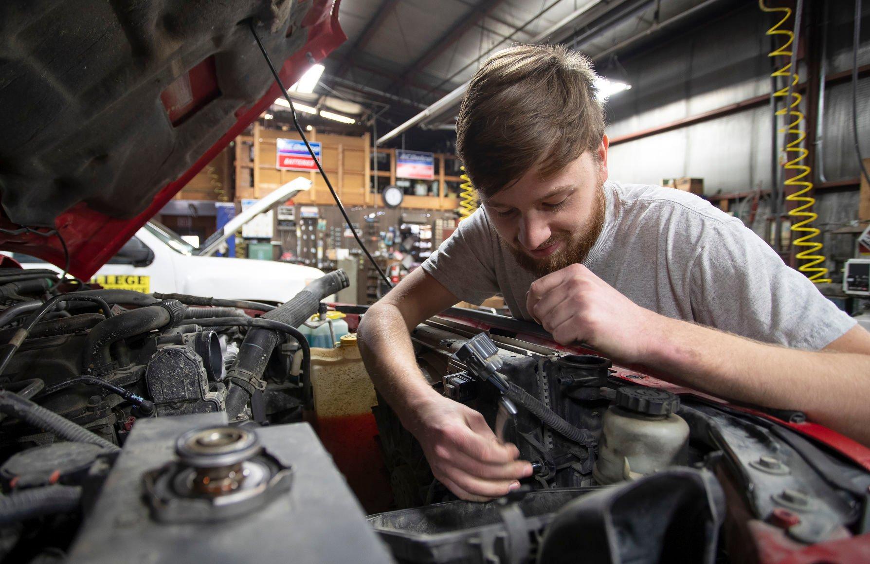 Sheehan Auto’s new owner Luke Steele works on a car Monday in his shop on Desoto Avenue in East Dubuque, Ill.    PHOTO CREDIT: Stephen Gassman
