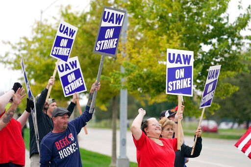 Members of the United Auto Workers strike outside of a John Deere plant, Wednesday, Oct. 20, 2021, in Ankeny, Iowa. About 10,000 UAW workers have gone on strike against John Deere since last Thursday at plants in Iowa, Illinois and Kansas. (AP Photo/Charlie Neibergall)    PHOTO CREDIT: Charlie Neibergall