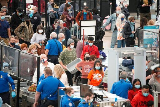 Travelers queue up at the south security checkpoint as traffic increases with the approach of the Thanksgiving Day holiday Tuesday at Denver International Airport in Denver.    PHOTO CREDIT: David Zalubowski