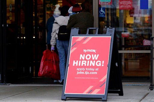 A hiring sign is displayed outside of a retail store in Vernon Hills, Ill., on Nov. 13. The number of Americans applying for unemployment benefits plummeted last week to the lowest level in more than half a century.    PHOTO CREDIT: Nam Y. Huh