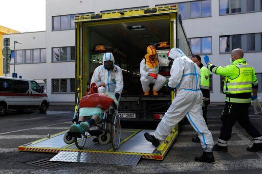 FILE - Health care workers transport a COVID-19 patient, in Ceska Lipa, Czech Republic, Thursday, March 18, 2021. Coronavirus infections in the Czech Republic have soared to a record level again, reaching almost 26,000 daily cases. The Health Ministry says the daily tally hit 25,864 on Tuesday, Nov. 23, 2021, about 3,000 more than the previous record registered on Friday.(AP Photo/Petr David Josek, File)    PHOTO CREDIT: Petr David Josek