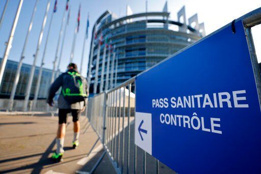 A man walks to the Health Pass control zone outside the European Parliament in Strasbourg, eastern France, Wednesday, Nov.24, 2021.Infections and virus-related hospitalizations and deaths are on the rise in France in recent weeks, and the government is stepping up enforcement of the health pass and encouraging people to get booster shots (AP Photo/Jean-Francois Badias)    PHOTO CREDIT: Jean-Francois Badias