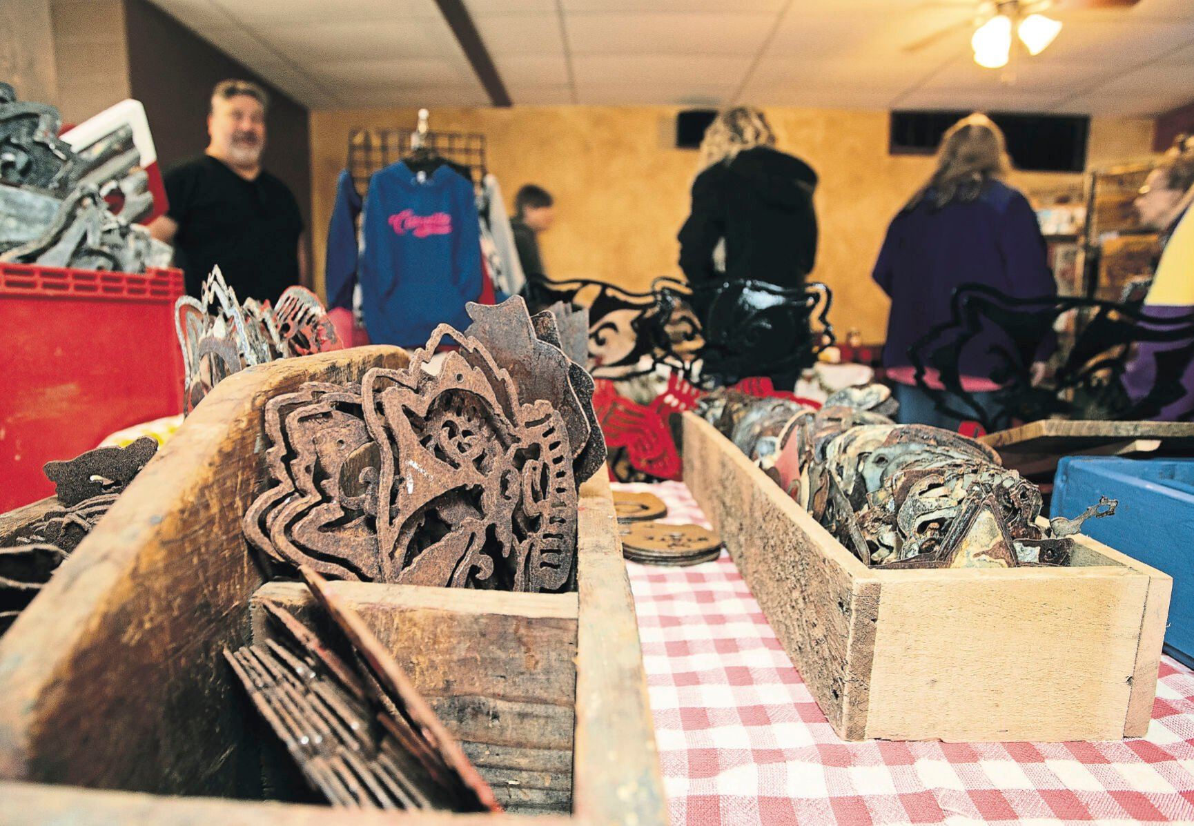 Shoppers look at the creations from Big River Rustics at a craft fair held at J&J’s Sandbar in Cassville, Wis.    PHOTO CREDIT: Stephen Gassman