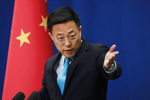 FILE - In this file photo taken Monday, Feb. 24, 2020, Chinese Foreign Ministry spokesperson Zhao Lijian speaks during a daily briefing at the Ministry of Foreign Affairs office in Beijing. China is threatening to take “firm countermeasures" if the U.S. proceeds with a diplomatic boycott of February