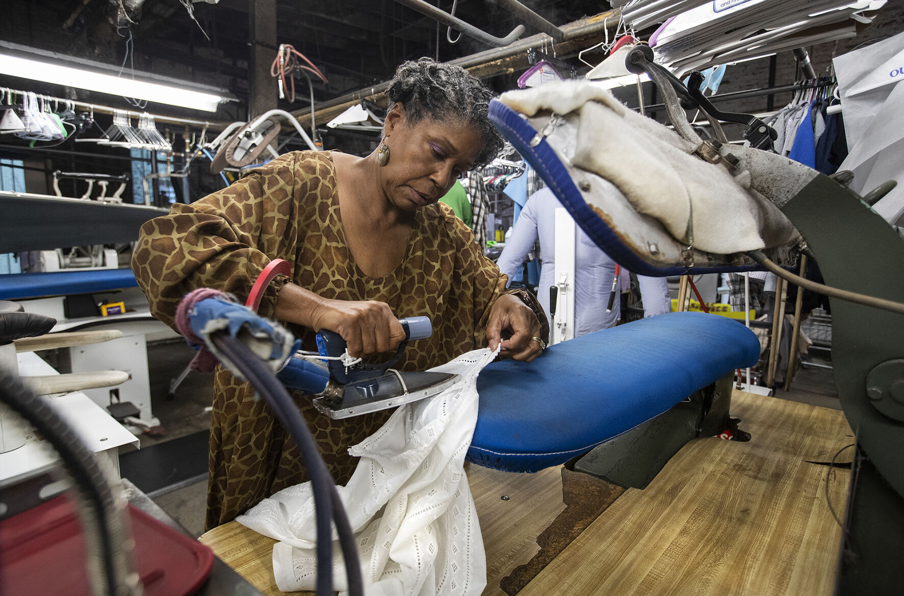 Vivian Bowers, the owner of Bowers & Sons Cleaners, a second-generation dry cleaner in South Los Angeles, irons a shirt. U.S. dry cleaning prices are up 6.9% year over year, higher than the overall inflation of 6.2%.     PHOTO CREDIT: Tribune News Service