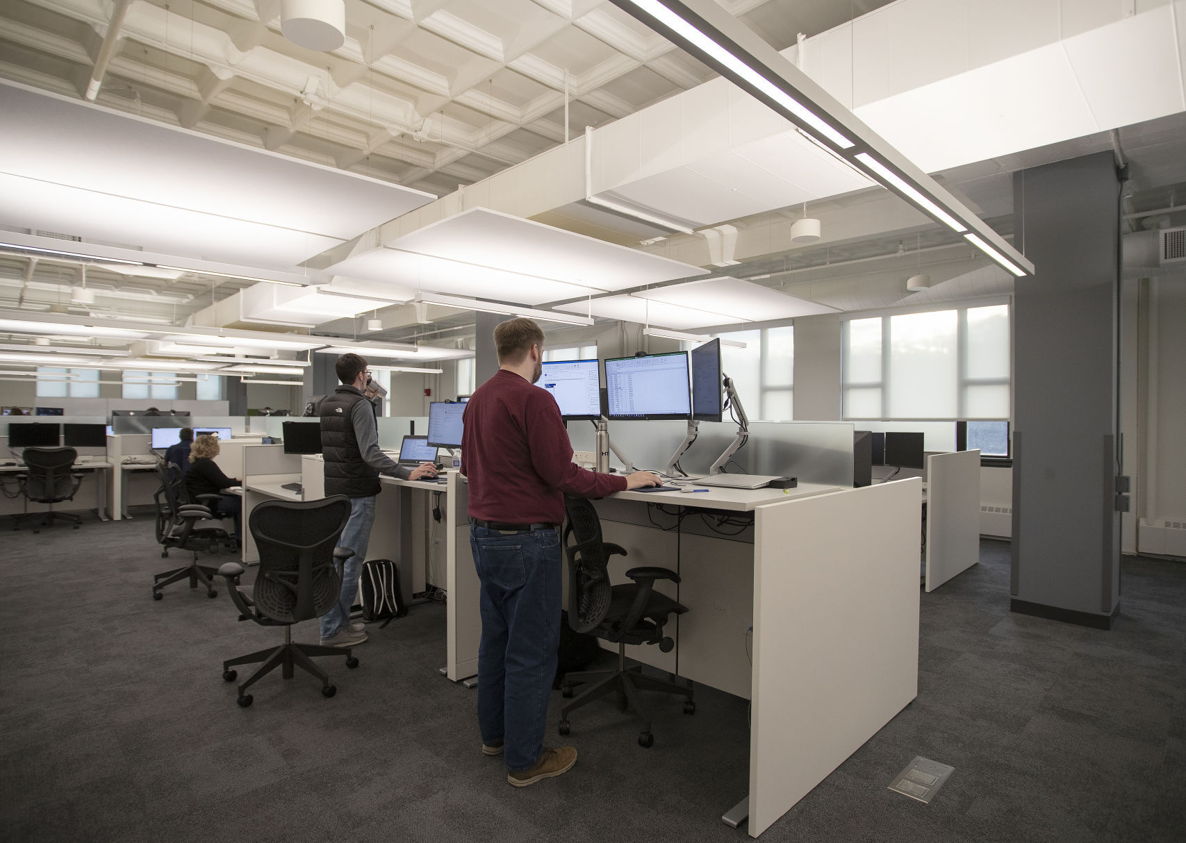Employees utilize ergonomic and adjustable standing desks at the recently renovated building at 700 Lucust Street in Dubuque on Wednesday, Dec. 8, 2021.    PHOTO CREDIT: Stephen Gassman