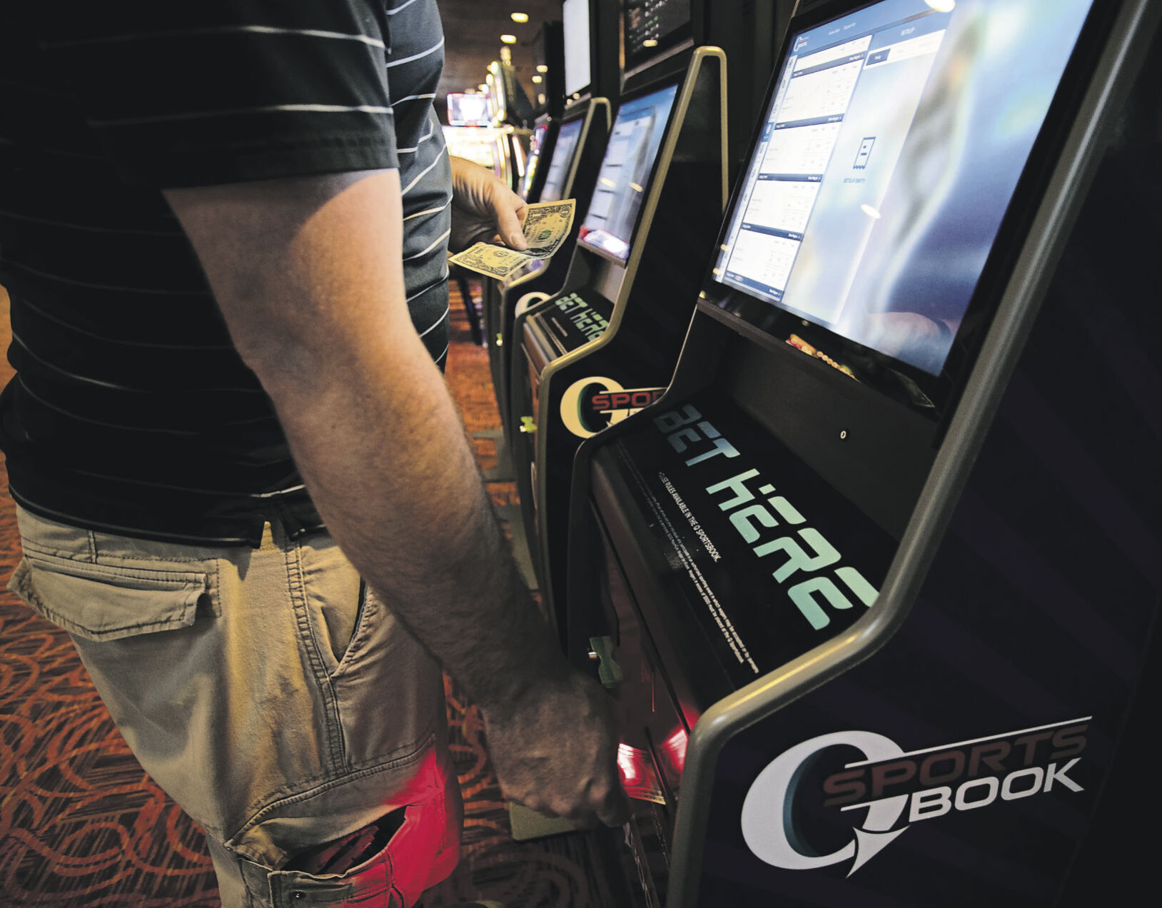 A customer places a bet at a kiosk in Q Sportsbook inside Q Casino in Dubuque on Wednesday, Sept. 1, 2021.    PHOTO CREDIT: Stephen Gassman