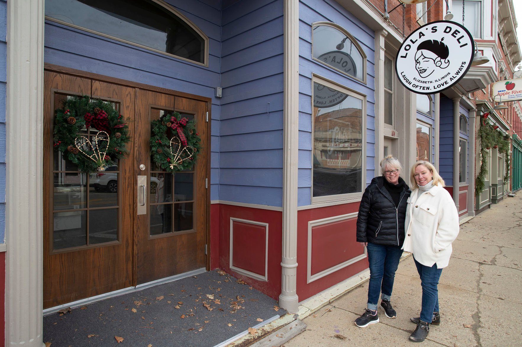 Lola’s Deli co-owners Carrie Clark (left) and Susan Hanley pose outside the site of their Elizabeth, Ill., business, set to open next month.    PHOTO CREDIT: Stephen Gassman, Telegraph Herald
