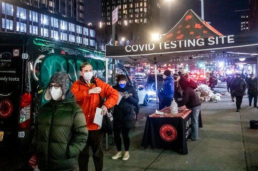 FILE - People wait on line to get tested for COVID-19 on Dec. 21, 2021, in New York. More than a year after the vaccine was rolled out, new cases of COVID-19 in the U.S. have soared to the highest level on record at over 265,000 per day on average, a surge driven largely by the highly contagious omicron variant. (AP Photo/Brittainy Newman, File)    PHOTO CREDIT: Brittainy Newman