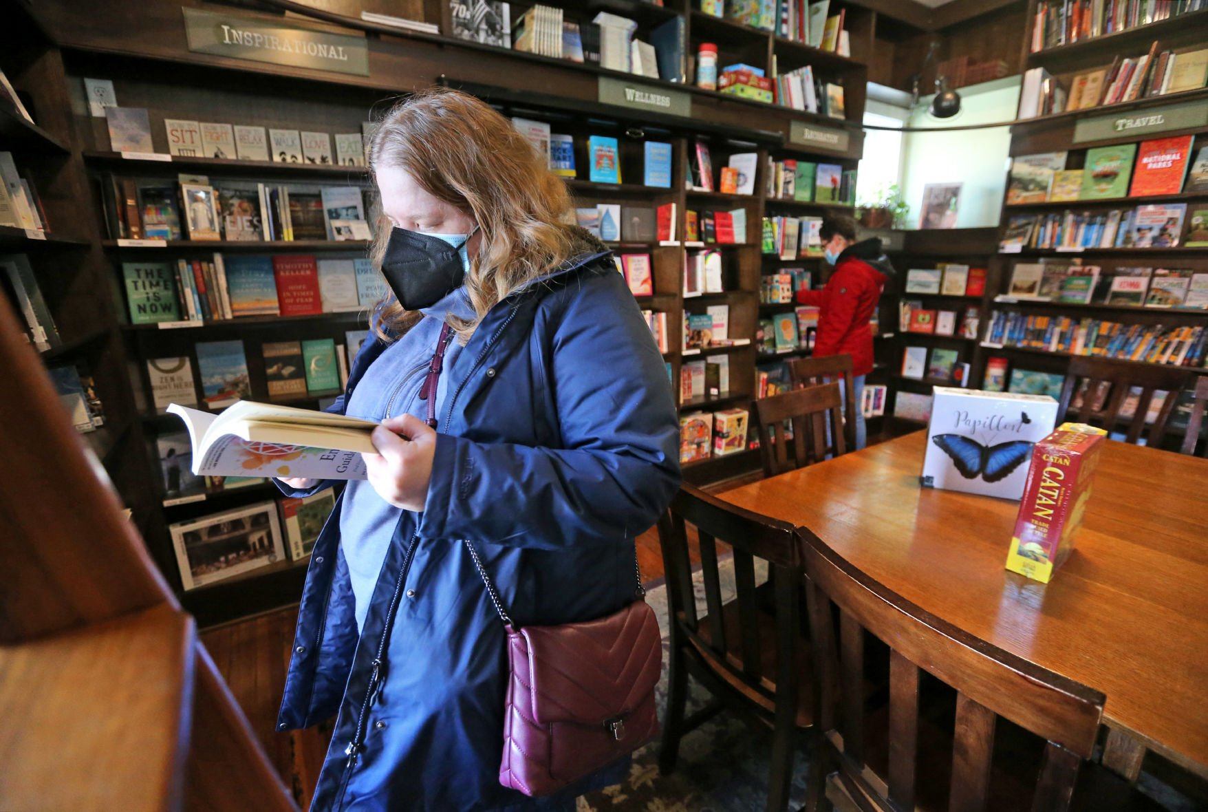 Rachel Seymour (left), of Bloomington, Ind., and Nicole Schmitt, of Dubuque, browse a selection of books at River Lights Bookstore in Dubuque on Wednesday.    PHOTO CREDIT: JESSICA REILLY