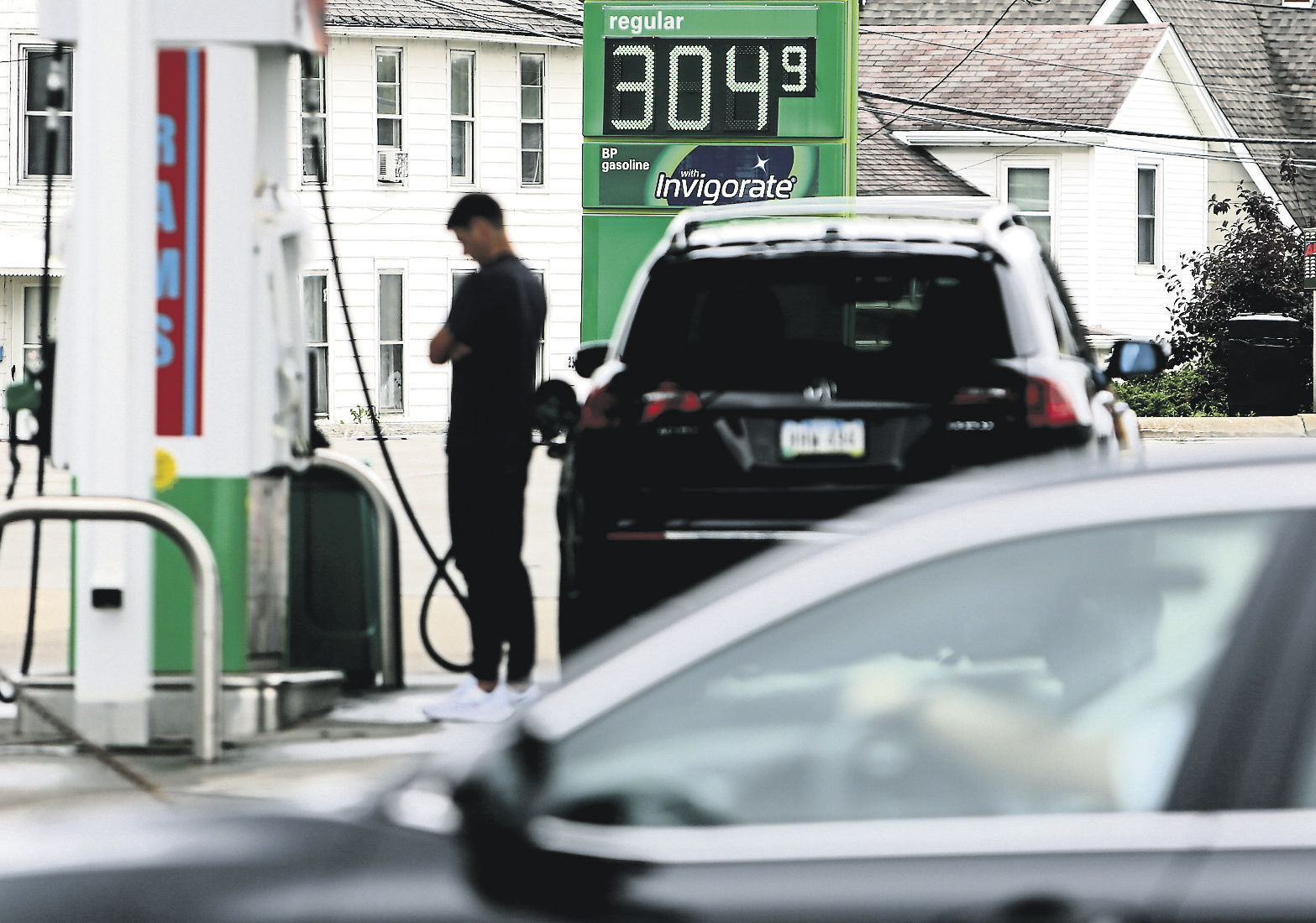 A person puts gas into their vehicle at Kwik Stop at the corner of University Avenue and Asbury Road in June. High gas prices hit the area for much of 2021 and inflation could continue at relatively high rates this year.    PHOTO CREDIT: Dave Kettering