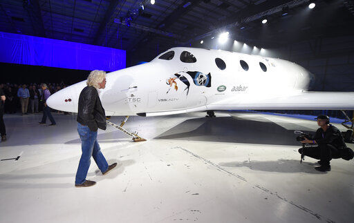 FILE - Sir Richard Branson walks in front of Virgin Galactic