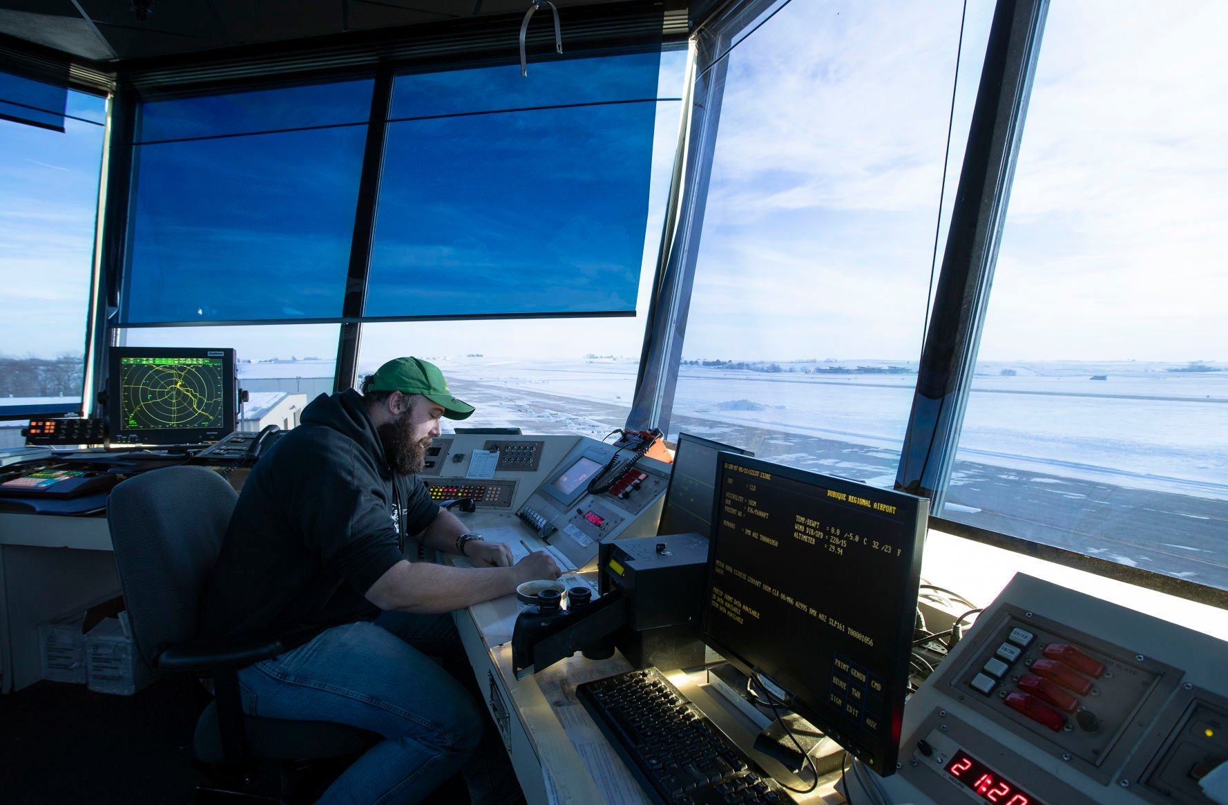 Alan Brown works in the air traffic control tower at Dubuque Regional Airport on Tuesday.    PHOTO CREDIT: Stephen Gassman