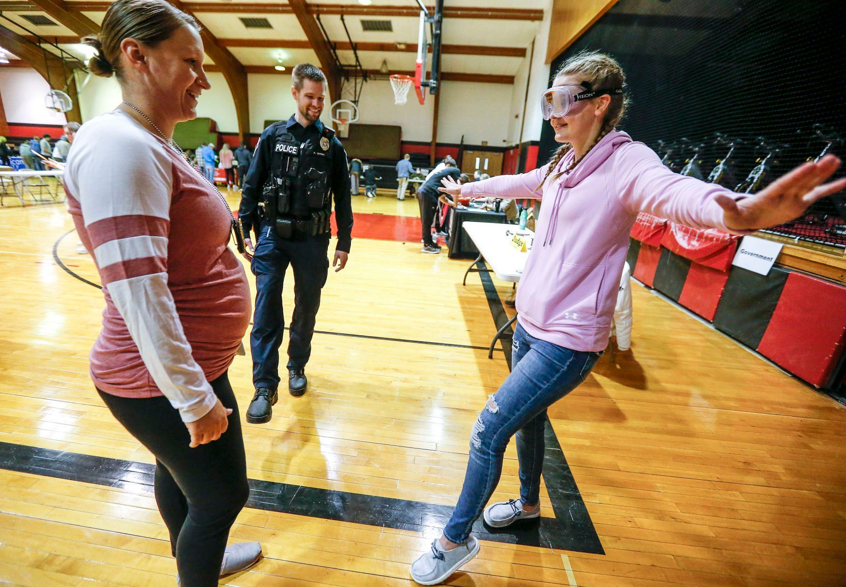 Dyersville, Iowa, Assistant Police Chief Molly Dupont and police officer Andrew Siitari give Western Dubuque High School senior Sidney Heims a sobriety test using goggles to simulate intoxication as part of a Real Life Academy sponsored by Dyersville Area Chamber of Commerce at the school on Tuesday, Jan. 18, 2022.    PHOTO CREDIT: Dave Kettering
