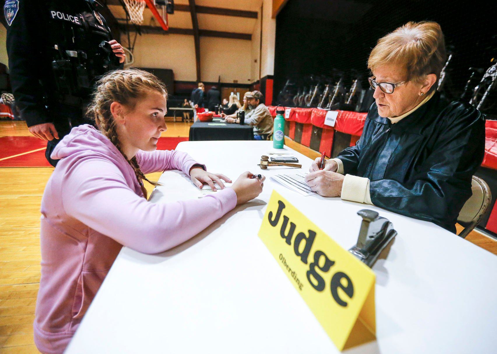 Shirley Olberding hands down the punishment for a simulated offense to Western Dubuque High School senior Sidney Heims as part of a Real Life Academy sponsored by Dyersville Area Chamber of Commerce at the school on Tuesday, Jan. 18, 2022.    PHOTO CREDIT: Dave Kettering