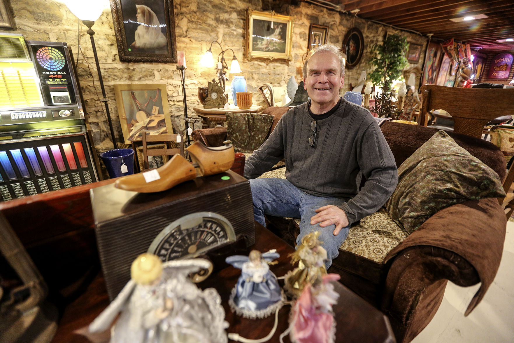 Lancaster (Wis.) native John Myers sits in his store, JEM Antiques. Myers is selling off his collections with all proceeds other than the cost of rent benefiting the Grant County Humane Society.    PHOTO CREDIT: Dave Kettering