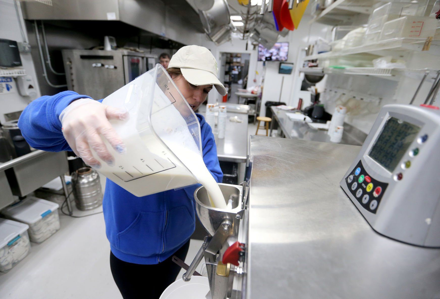 Whitney Beyer makes ice cream at Vesperman Farms in Lancaster, Wis., on Monday.    PHOTO CREDIT: JESSICA REILLY
