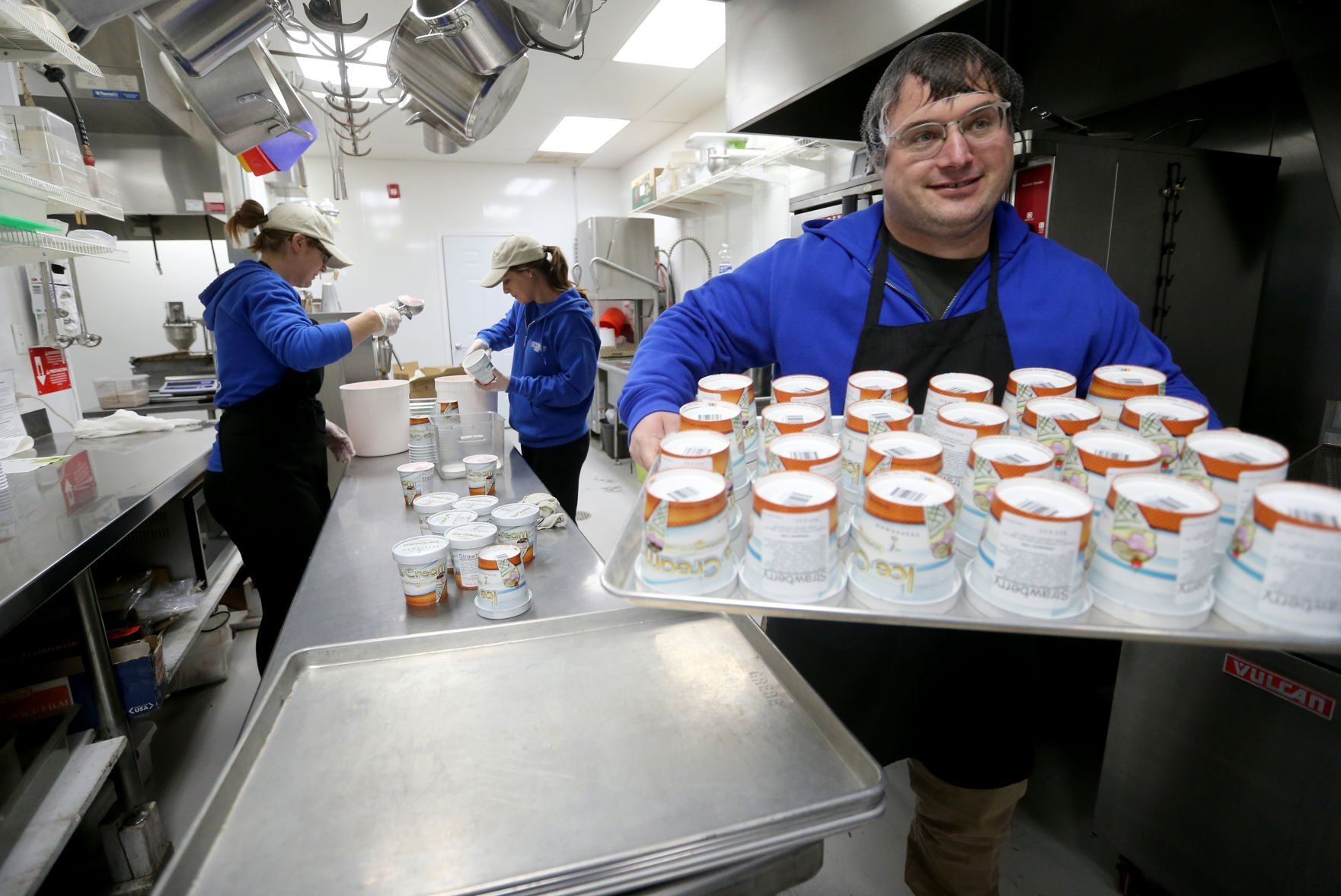 Kyle Vesperman takes a tray of packaged ice cream to the cooler at Vesperman Farms in Lancaster, Wis., on Monday.    PHOTO CREDIT: JESSICA REILLY