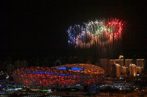 Fireworks, forming the Olympic rings, illuminate the sky during the opening ceremony of the 2022 Winter Olympics in Beijing. Through the first four nights of competition, NBC is on track for the lowest-rated Winter Games in history.    PHOTO CREDIT: Li Xin