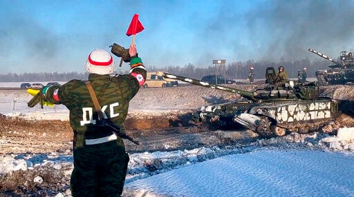 In this photo taken from video provided by the Russian Defense Ministry Press Service on Tuesday, Feb. 15, 2022, Russian army tanks move back to their permanent base after drills in Russia. In what could be another sign that the Kremlin would like to lower the temperature, Russia