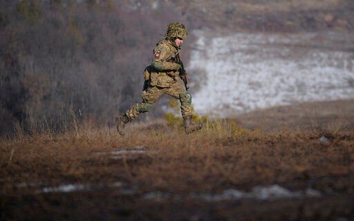 A Ukrainian serviceman runs during an exercise in the Joint Forces Operation, in the Donetsk region, eastern Ukraine, Tuesday, Feb. 15, 2022. Russia said Tuesday that some units participating in military exercises would begin returning to their bases, adding to glimmers of hope that the Kremlin may not be planning to invade Ukraine imminently. (AP Photo/Vadim Ghirda)    PHOTO CREDIT: Vadim Ghirda