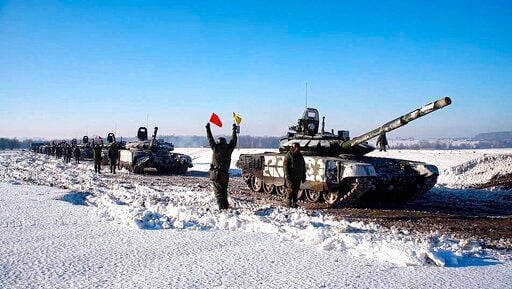 In this photo taken from video provided by the Russian Defense Ministry Press Service on Tuesday, Feb. 15, 2022, Russian army tanks stand ready to move back to their permanent base after drills in Russia. In what could be another sign that the Kremlin would like to lower the temperature, Russia