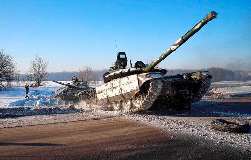 In this photo taken from video provided by the Russian Defense Ministry Press Service on Tuesday, Feb. 15, 2022, Russian army tanks move back to their permanent base after drills in Russia. In what could be another sign that the Kremlin would like to lower the temperature, Russia