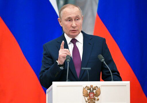 Russian President Vladimir Putin gestures speaking during a joint news conference with German Chancellor Olaf Scholz following their talks in the Kremlin in Moscow, Russia, Tuesday, Feb. 15, 2022. Putin says Moscow is ready for security talks with the U.S. and NATO, as the Russian military announced a partial troop withdrawal from drills near Ukraine — new signs that may suggest a Russian invasion of its neighbor isn