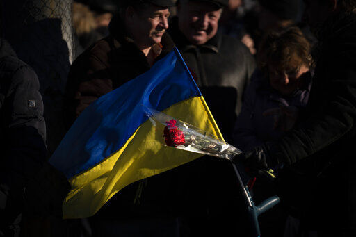 People attend a ceremony to mark the anniversary of the withdrawal of Soviet troops from Afghanistan in the city of Kyiv, Ukraine, Tuesday, Feb. 15, 2022. Russia says that some units participating in military exercises will begin returning to their bases. That adds to glimmers of hope that the Kremlin may not be planning to invade Ukraine imminently. (AP Photo/Emilio Morenatti)    PHOTO CREDIT: Emilio Morenatti