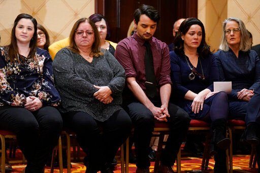Families of the victims of the Newtown shooting and attorneys listen during a news conference in Trumbull, Conn., on Tuesday.    PHOTO CREDIT: Seth Wenig